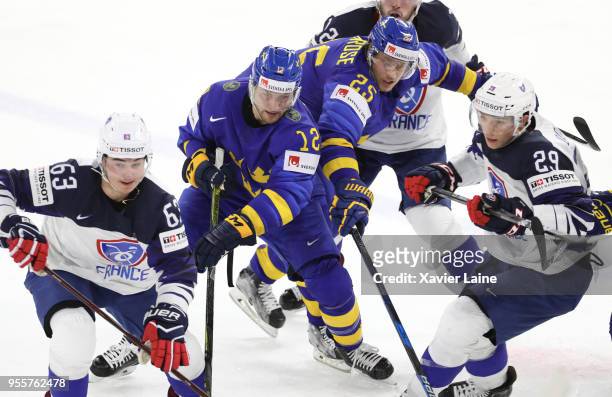 Alexandre Texier and Florian Douay of France in action with Johan Larsson and Jacob De La Rose of Sweden during the 2018 IIHF Ice Hockey World...