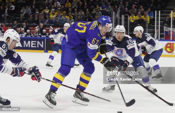 Rickard Rakell of Sweden in action with Alexandre Texier and Damien Raux of France during the 2018 IIHF Ice Hockey World Championship Group A between...