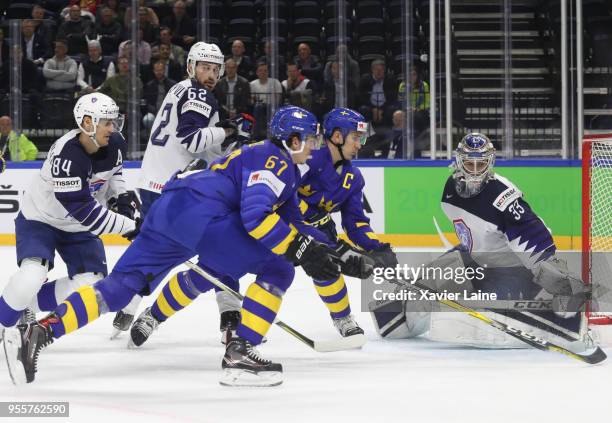 Rickard Rakell and Mikael Backlund of Sweden in action over Ronan Quemener of France during the 2018 IIHF Ice Hockey World Championship Group A...