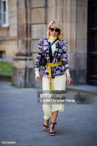 Gitta Banko wearing a tweed jacket by AirField, light-yellow turtleneck sweater from Zara, yellow pleated skirt from Mango, yellow belt by Off-White,...