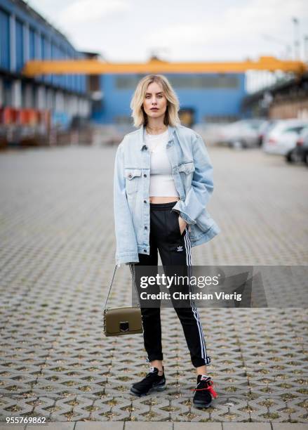 Lisa Hahnbueck wearing light blue Off White jeans jacket, Gina Tricot cropped top, black Adidas track pants, nike paper max x off white sneaker,...