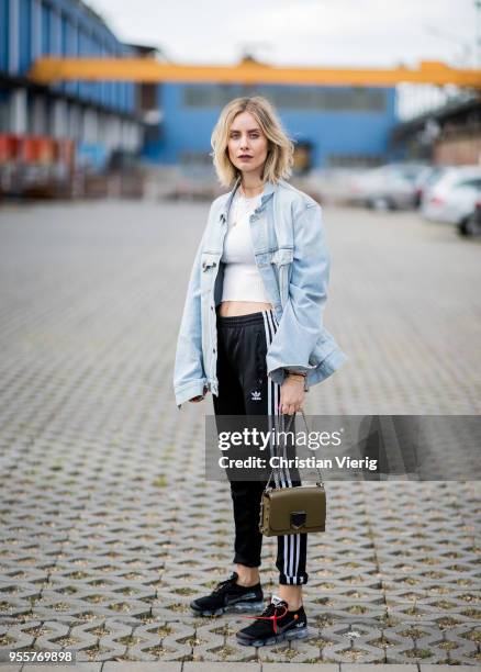 Lisa Hahnbueck wearing light blue Off White jeans jacket, Gina Tricot cropped top, black Adidas track pants, nike paper max x off white sneaker,...