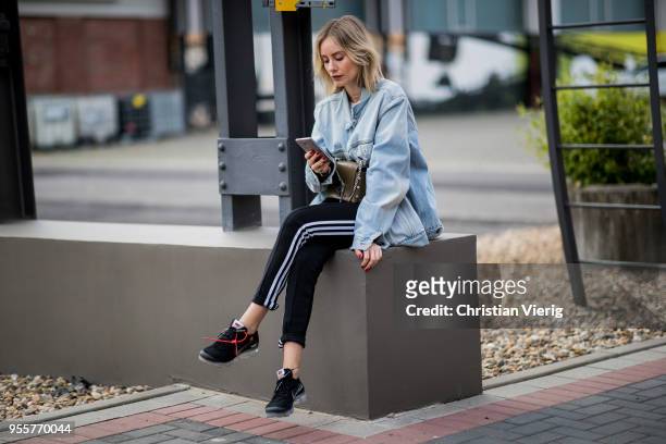 Lisa Hahnbueck wearing light blue Off White jeans jacket, Gina Tricot cropped top, black Adidas track pants, nike paper max x off white sneaker,...