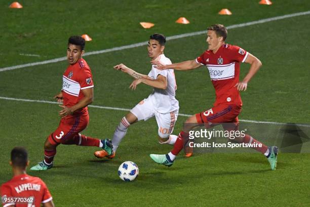 Atlanta United FC midfielder Miguel Almiron controls the ball against the Chicago Fire defender Brandon Vincent and Chicago Fire defender Grant...