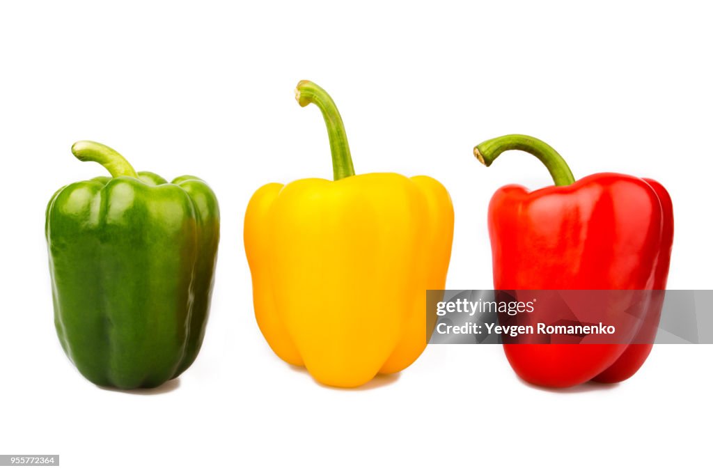 Green, yellow and red bell peppers isolated on white background