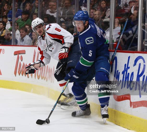 Alex Ovechkin of the Washington Capitals loses his stick as Christian Ehrhoff of the Vancouver Canucks plays the puck during their game at General...