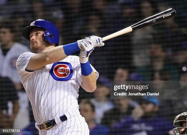 Ian Happ of the Chicago Cubs hits a two run home run in the 4th inning against the Miami Marlins at Wrigley Field on May 7, 2018 in Chicago, Illinois.