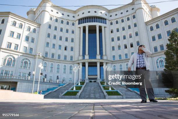 Pedestrian walks past the National Library of Tajikstan in Dushanbe, Tajikistan, on Saturday, April 21, 2018. Flung into independence after the...