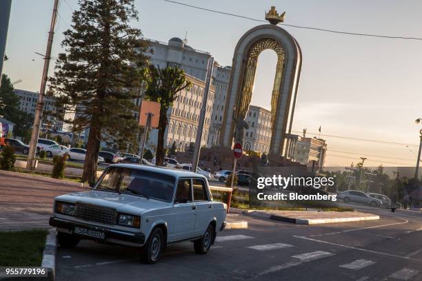 Car sits parked near the Statue of Ismoili Somoni in Dushanbe, Tajikistan, on Saturday, April 21, 2018. Flung into independence after the Soviet...