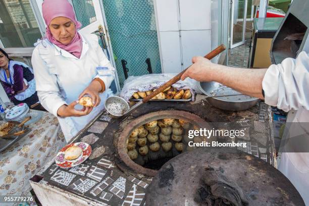 Meat pastries knows as 'Samsa' are cooked in an oven in Dushanbe, Tajikistan, on Sunday, April 22, 2018. Flung into independence after the Soviet...