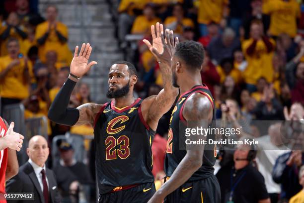 LeBron James and Jeff Green of the Cleveland Cavaliers high five in Game Four of the Eastern Conference Semifinals against the Toronto Raptors during...