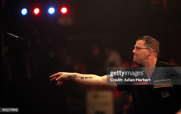 Steve West of England in action against Martin McCloskey of Northern Ireland during the First Round Match of World Professional Darts Championship at...