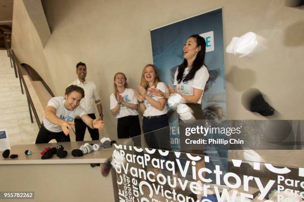 Craig Kielburger, Co Founder WE, tosses socks into the donation bin for the launch of #WeCareVancouver, a new initiative from Parq Vancouver and WE...