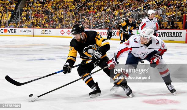 Bryan Rust of the Pittsburgh Penguins handles the puck against Lars Eller of the Washington Capitals in Game Six of the Eastern Conference Second...