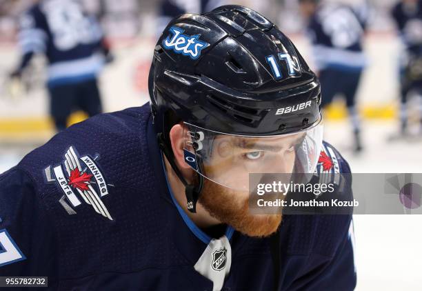 Adam Lowry of the Winnipeg Jets looks on during the pre-game warm up prior to NHL action against the Nashville Predators in Game Six of the Western...