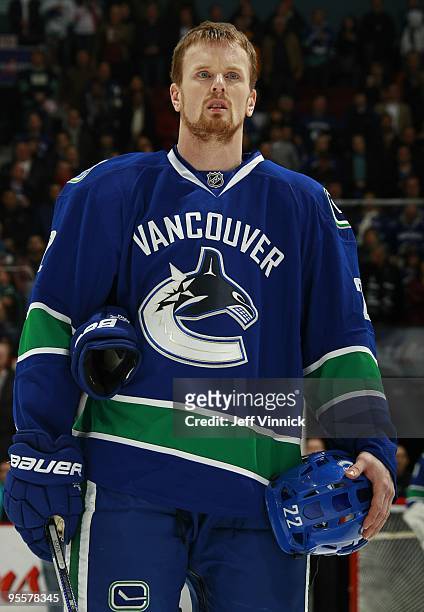 Daniel Sedin of the Vancouver Canucks listens to the National Anthems before their game against the Los Angeles Kings at General Motors Place on...