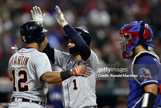 Leonys Martin of the Detroit Tigers celebrates with Jose Iglesias after hitting a two-run homerun in the sixth inning against the Texas Rangers at...