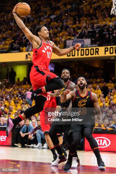DeMar DeRozan of the Toronto Raptors goes up for a dunk over Tristan Thompson of the Cleveland Cavaliers during the first half of Game 4 of the...