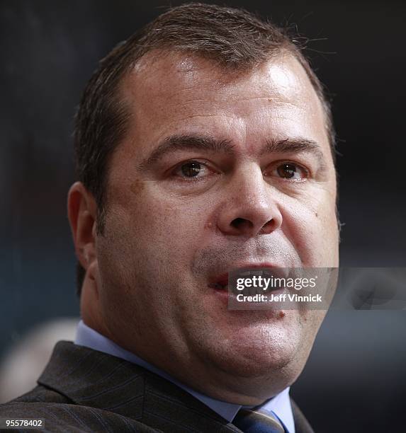 Head coach Alain Vigneault of the Vancouver Canucks looks on from the bench during their game against the Minnesota Wild at General Motors Place on...