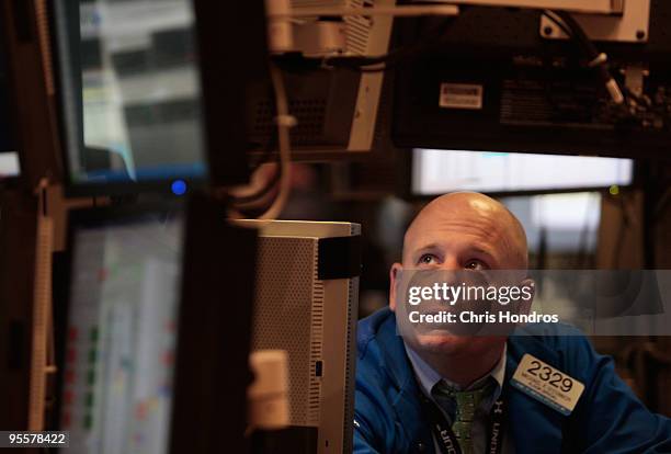 Financial professional works at his station on the floor of the New York Stock Exchange near the end of the trading day on January 4, 2010 in New...
