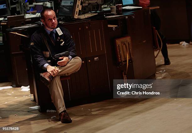 Financial professional sits with his handheld computer on the floor of the New York Stock Exchange near the end of the trading day on January 4, 2010...