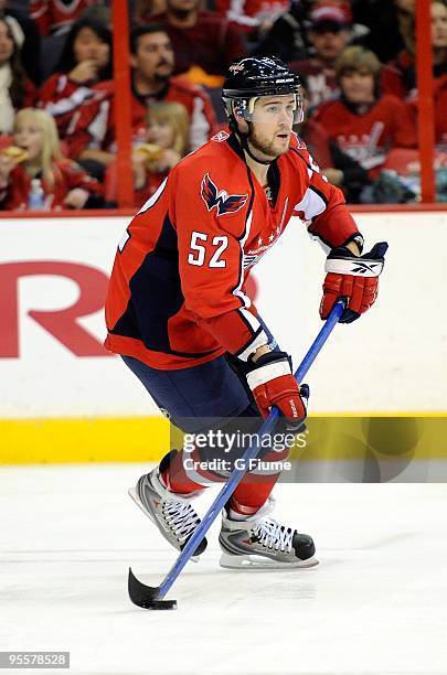 Mike Green of the Washington Capitals handles the puck against the Carolina Hurricanes at the Verizon Center on December 28, 2009 in Washington, DC.