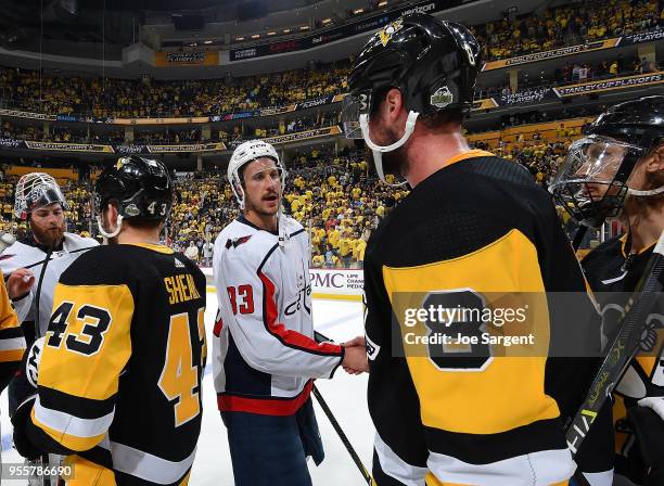 Jay Beagle of the Washington Capitals shakes hands with Brian Dumoulin of the Pittsburgh Penguins after a 2-1 overtime win in Game Six of the Eastern...