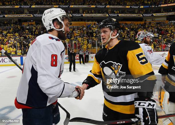 Alex Ovechkin of the Washington Capitals shakes hands with Jake Guentzel of the Pittsburgh Penguins after a 2-1 overtime win in Game Six of the...