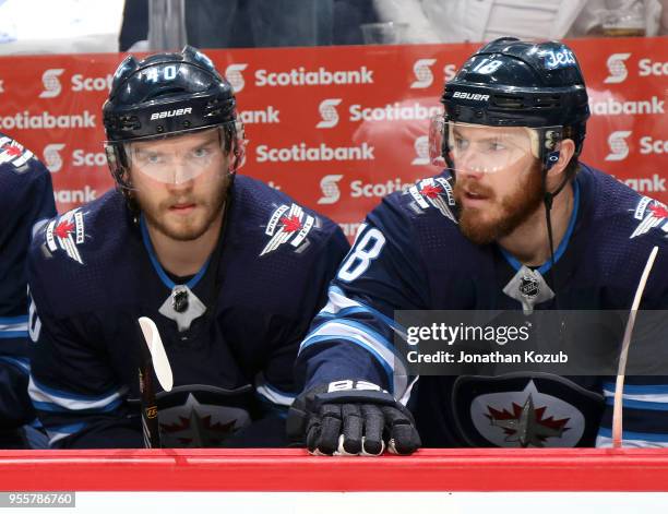 Joel Armia and Bryan Little of the Winnipeg Jets look on from the bench prior to puck drop against the Nashville Predators in Game Six of the Western...