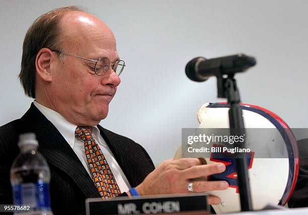 Rep. Stephen Cohen, a member of the House Judiciary Committee, examines one of Lem Barney's helmets during a U.S. House Judiciary field hearing...