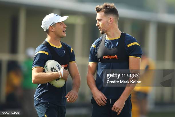 Mitchell Moses and Clint Gutherson speak as they warm-up ahead of a Parramatta Eels NRL training session at the Old Saleyards Reserve on May 8, 2018...