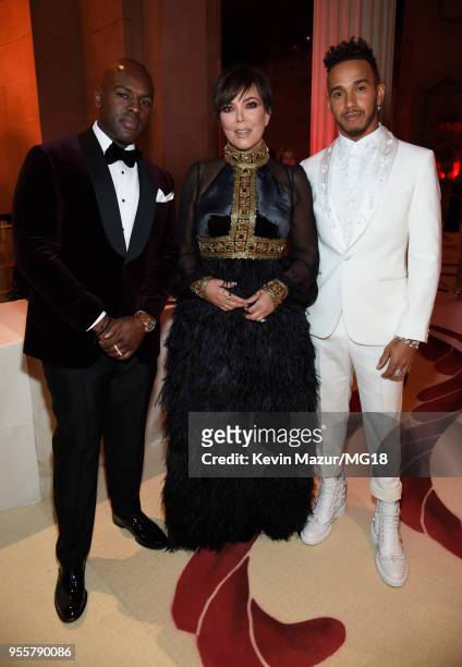 Corey Gamble, Kris Jenner, and Lewis Hamilton attend the Heavenly Bodies: Fashion & The Catholic Imagination Costume Institute Gala at The...