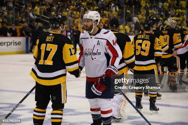 Brooks Orpik of the Washington Capitals shakes hands with Bryan Rust of the Pittsburgh Penguins after a 4-2 series win after Game Six of the Eastern...