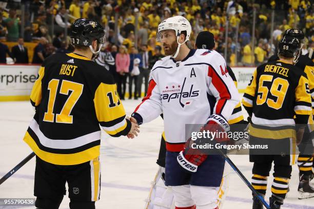 Brooks Orpik of the Washington Capitals shakes hands with Bryan Rust of the Pittsburgh Penguins after a 4-2 series win after Game Six of the Eastern...