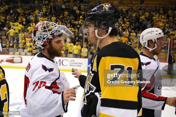 Braden Holtby of the Washington Capitals shakes hands with Evgeni Malkin of the Pittsburgh Penguins after a 4-2 series win in the Eastern Conference...