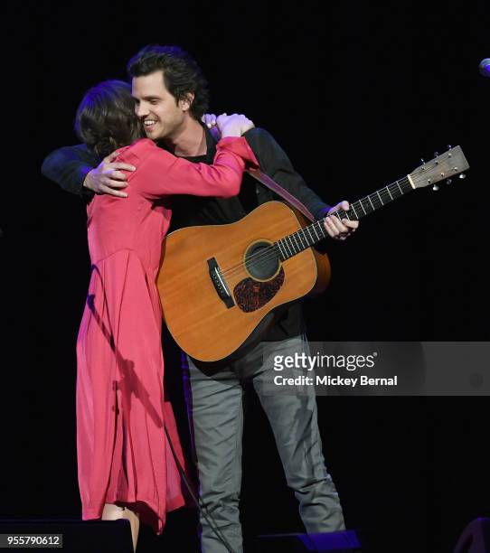 Jillian Jacqueline and Steve Moakler hug onstage during the 3rd Annual AIMP Awards at Ryman Auditorium on May 7, 2018 in Nashville, Tennessee.