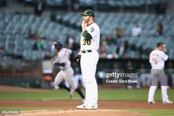 George Springer of the Houston Astros rounds the bases after he hit a three-run home run in the second inning off of Brett Anderson of the Oakland...