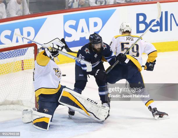 Mathieu Perreault of the Winnipeg Jets fights for space with Pekka Rinne and Roman Josi of the Nashville Predators in Game Six of the Western...