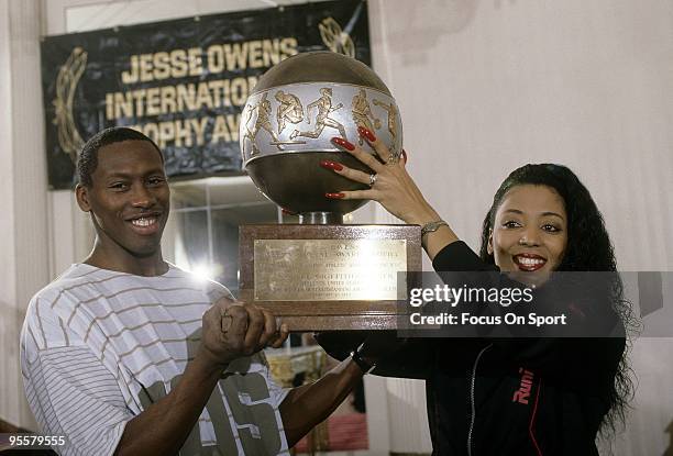 Florence Griffith Joyner with her husband AL Joyner holding the "Jesse Owens International Awards Trophy" presented to her by the International...