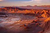 Golden sunset light casting strong shadow on the eerie moonscape at the Moon Valley, Atacama desert, Chile.