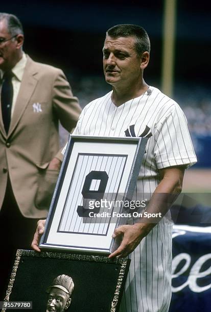 Roger Maris retired New York Yankee holds a framed number 9 on the day the New York Yankees retires his jersey, July 21, 1984 at Yankee Stadium in...