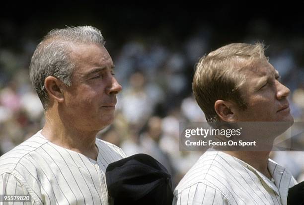 S: Outfielder Mickey Mantle formally of the New York Yankees stands with ex teammate Joe DiMaggio for the National Anthem before a circa 1970's Old...