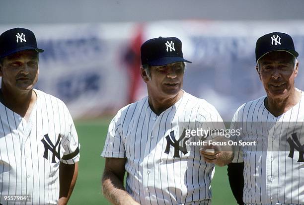 S: Outfielder Mickey Mantle formally of the New York Yankees stands with ex teammate Joe DiMaggio and Roger Maris before a circa 1980's Old timers...