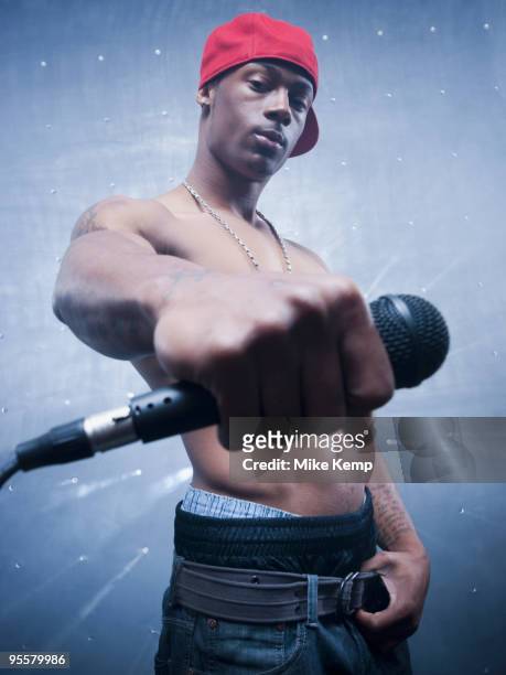 back lit african singer holding microphone - renegades v stars stockfoto's en -beelden