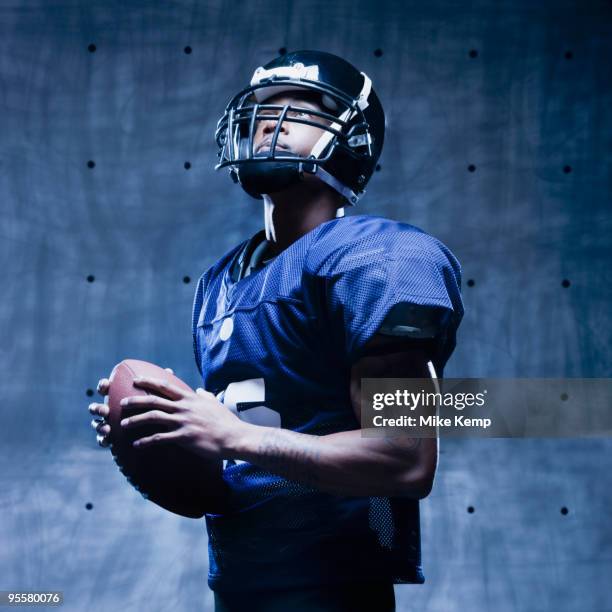 african football player holding football - safety american football player stockfoto's en -beelden