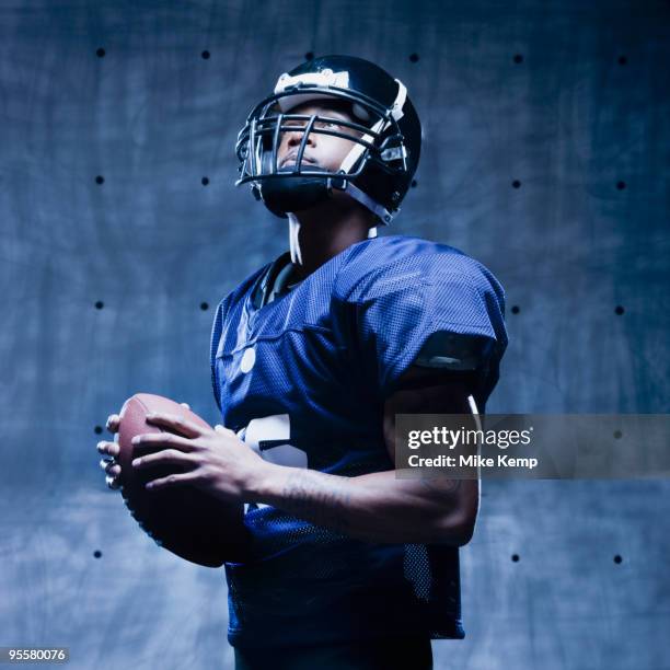 african football player holding football - football player stock pictures, royalty-free photos & images