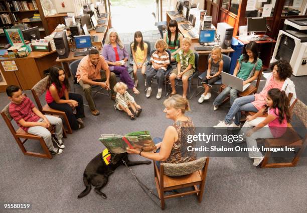 librarian reading book to group of children - los angeles events stock-fotos und bilder