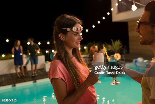 friends enjoying pool party - pool party night stock pictures, royalty-free photos & images