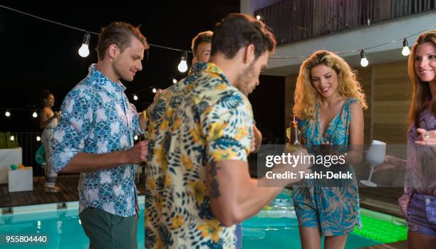 friends enjoying pool party - pool party night stock pictures, royalty-free photos & images