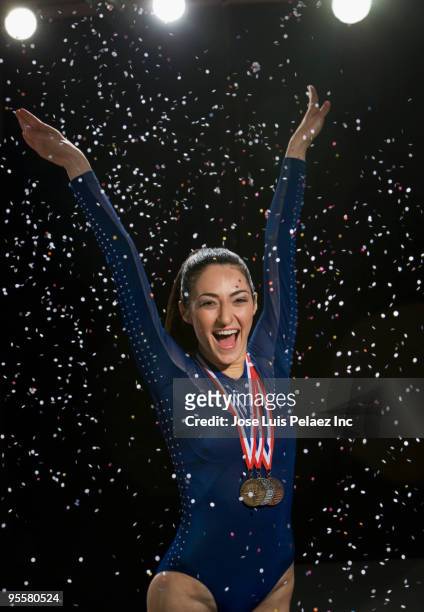 mixed race gymnast celebrating with medal - first light awards inside stock-fotos und bilder